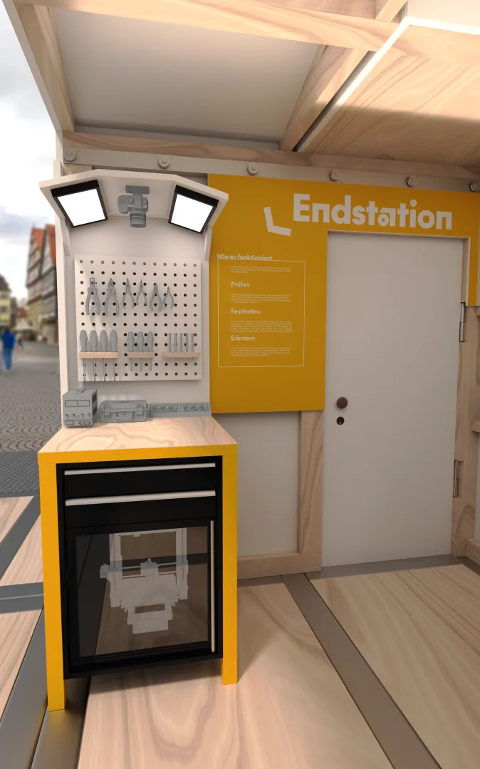 Die gelbe Endstation im Innenraum: eine Fotostation mit Bildschirm und Ablage neben der Tür.